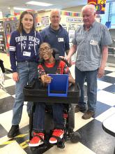 Group of people from ADHV with a woman in a wheelchair